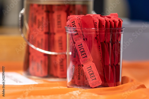Red raffle tickets in  jar