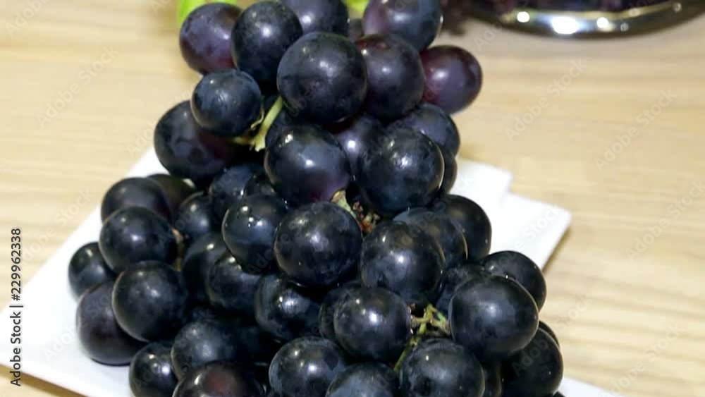 grapes on the plate, Dark grapes in plate on a wood background, fresh grapes in the plate, Black Grape grapes on the plate, Dark grapes in plate on a wood background, fresh grapes in the plate, Black Grape