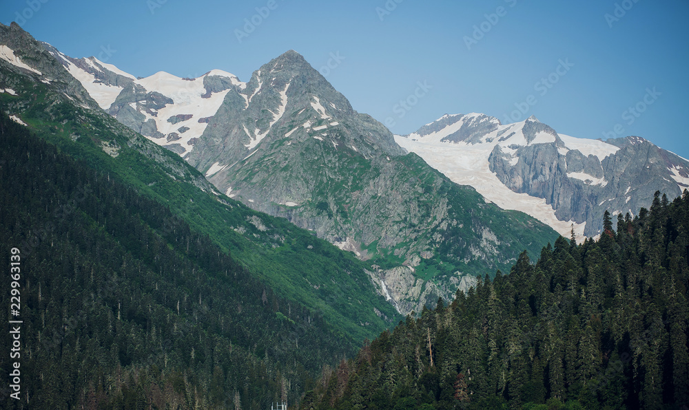 Caucasus mountain range in summer, snow-capped peaks, Sunny day