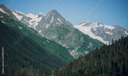 Caucasus mountain range in summer, snow-capped peaks, Sunny day