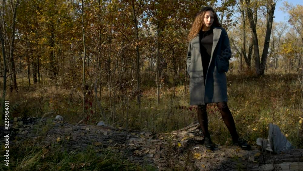 Young woman at fall, shallow depth of field, slow motion, wind in hair Young woman at fall, shallow depth of field, slow motion, wind in hair