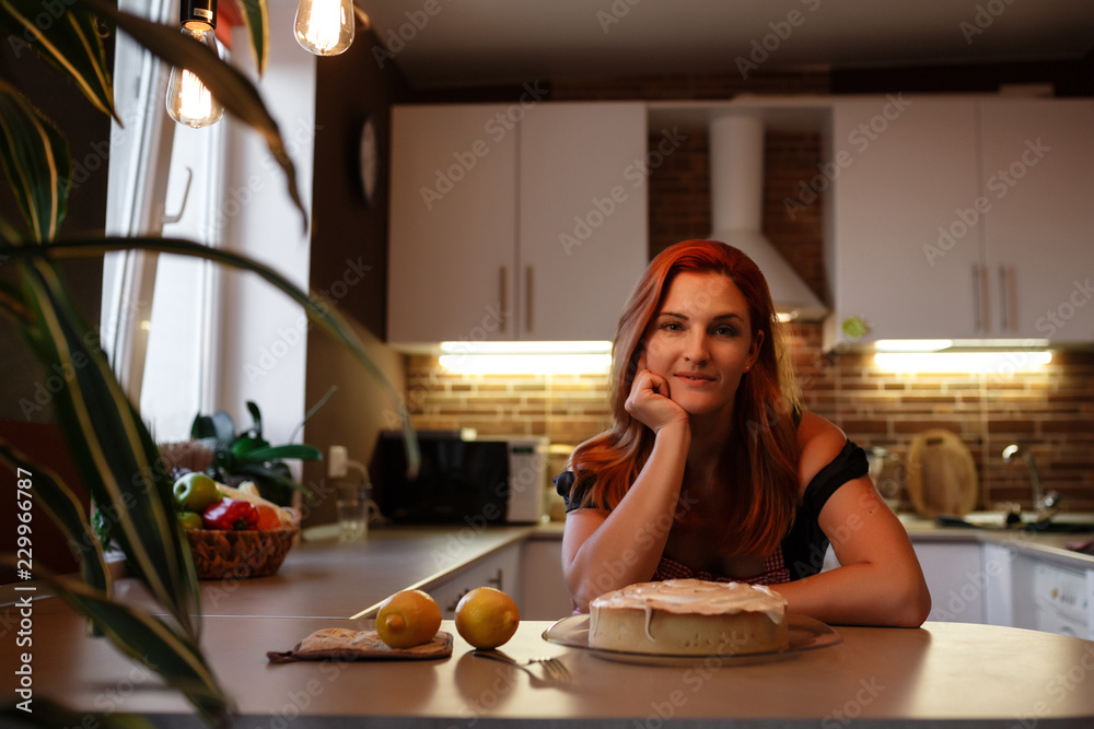 Photo of young pretty lady standing in kitchen