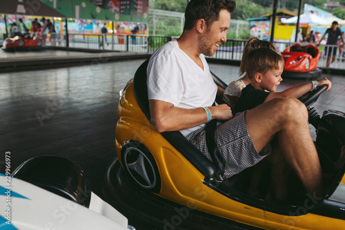 Dad and kids having fun on bumper cars photo