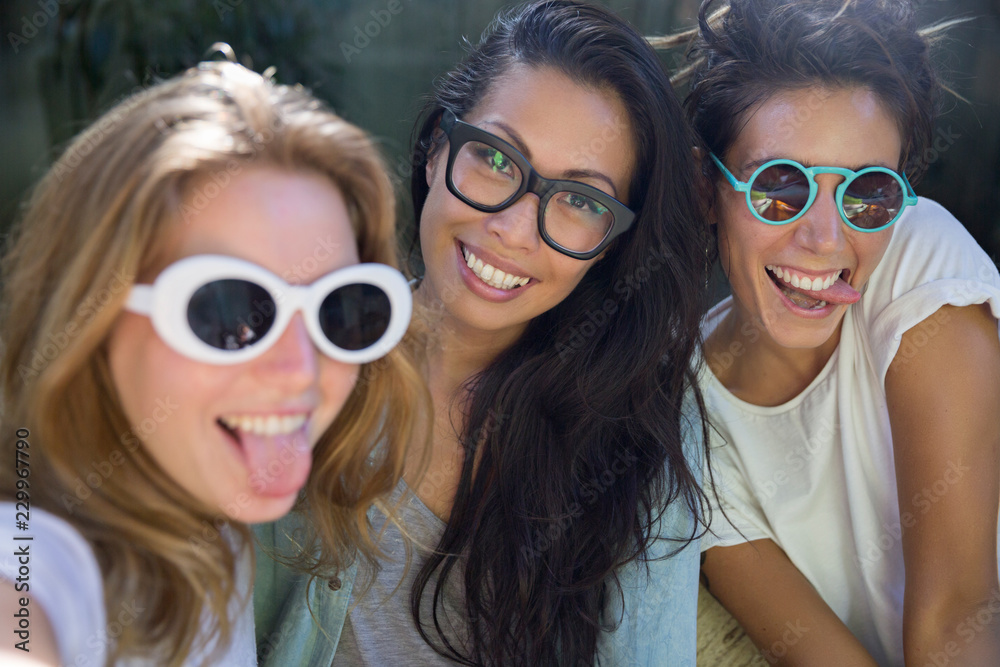 Three girlfriends taking a selfie together Three girlfriends taking a selfie together