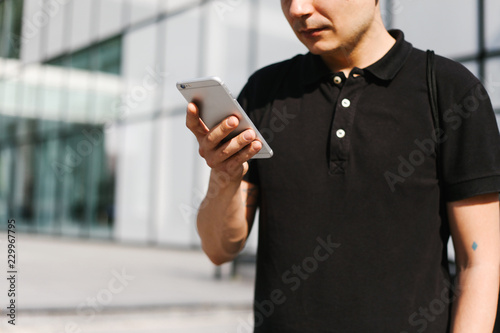 Male person hoding a smart phone photo