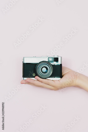 Hand holding a retro camera