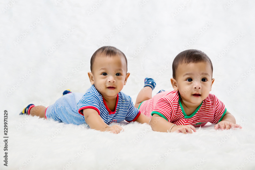 Infant twins sleeping.Newborn Babies Twins Sleep in Bed.Lovely sleep of the newborns babies on the bed. Cute twins baby boy is shooting in the studio. fashion image of baby and family. Infant twins sleeping.Newborn Babies Twins Sleep in Bed.Lovely sleep of the newborns babies on the bed. Cute twins baby boy is shooting in the studio. fashion image of baby and family.
