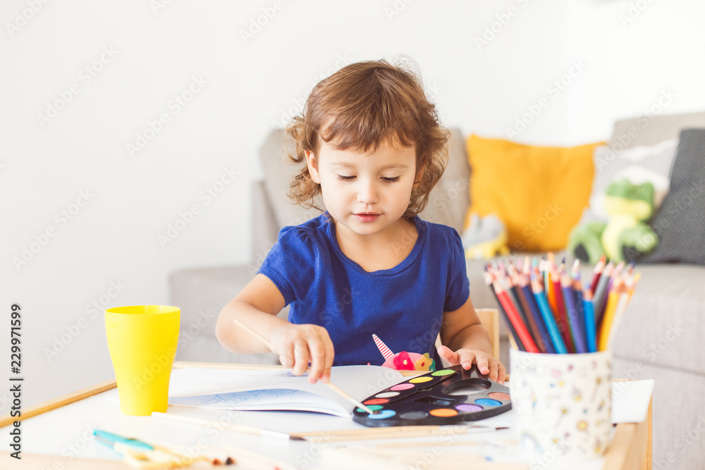 3 years girl painting at the small table at home. 3 years girl painting at the small table at home.