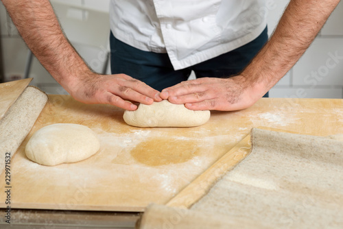 Man is kneading dough