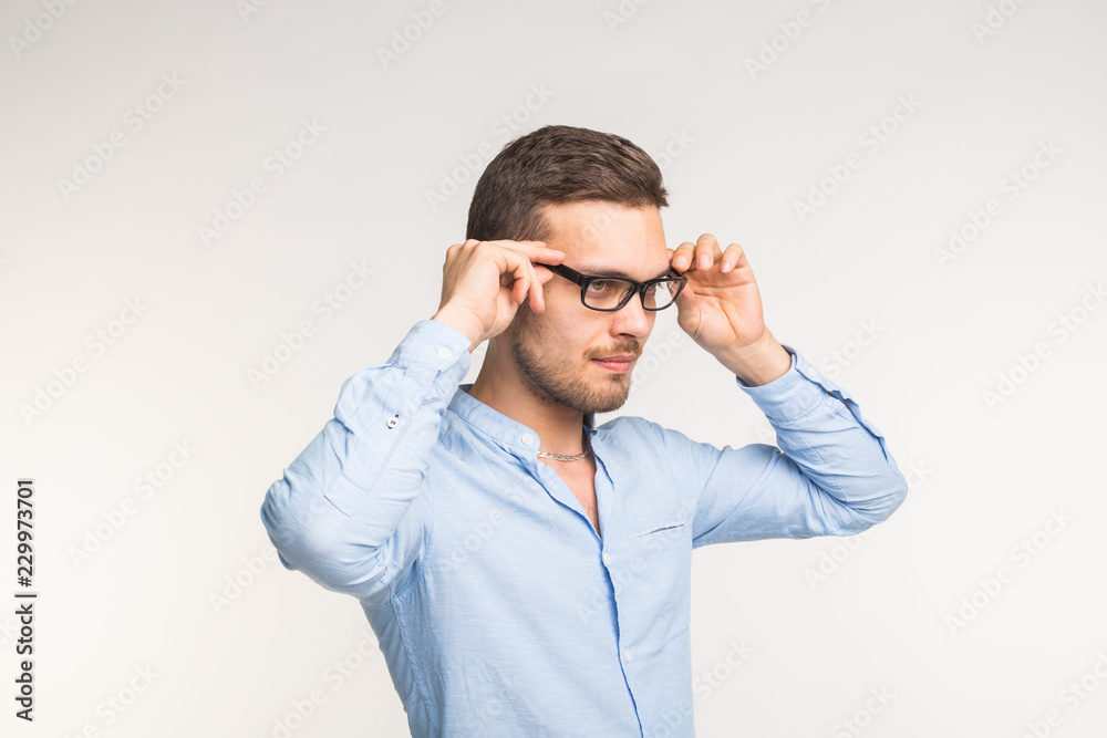 Vision and people concept - Handsome man wearing black glasses over white background Vision and people concept - Handsome man wearing black glasses over white background