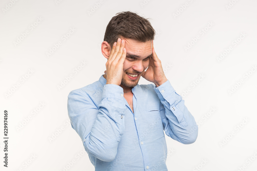 Emotions, health and people concept - handsome man thinking about something and has a headache on white background Emotions, health and people concept - handsome man thinking about something and has a headache on white background
