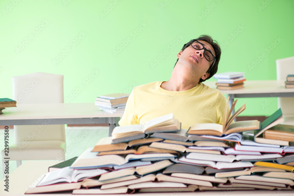 Student with too many books to read before exam
