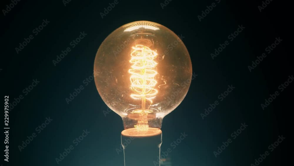 Old light bulb glowing with fluctuant energy