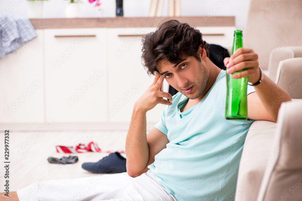 Young drunk handsome man after party at home Young drunk handsome man after party at home