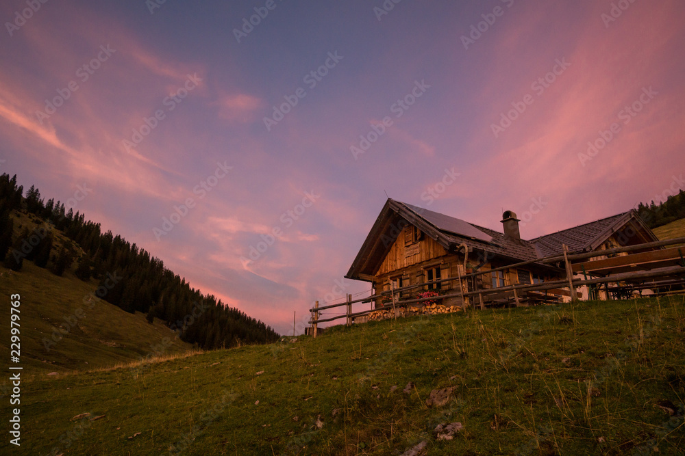 Alpine cabin at sunset