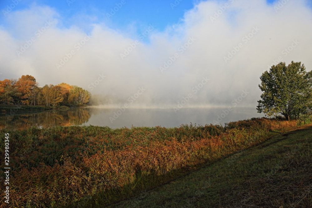 Fototapeta premium sunset on the river fog