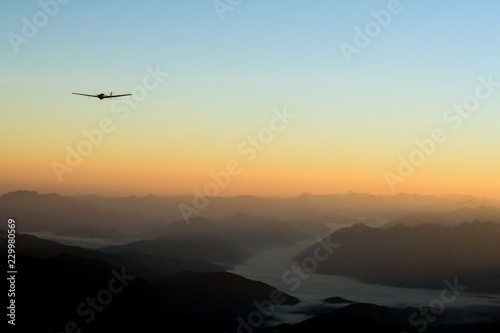 Sunrise in the alps with glider plane