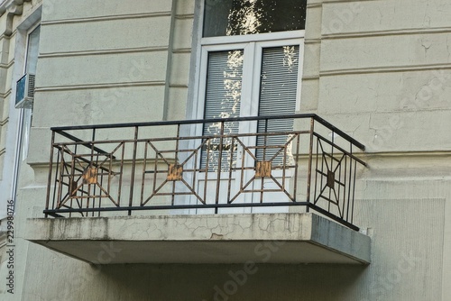 one balcony on the wall of a large house