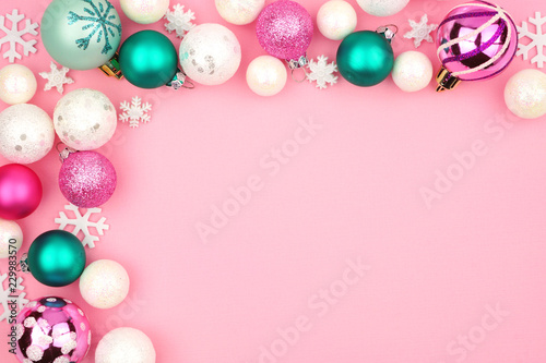 Modern pastel Christmas bauble corner border over a light pink background