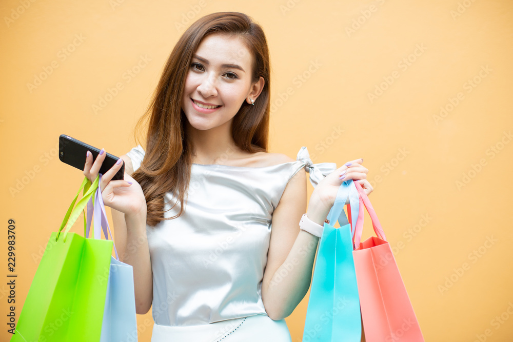 Woman use of mobile phone and holding shopping bag Woman use of mobile phone and holding shopping bag