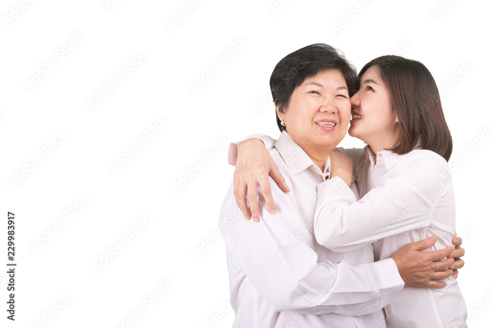 Beautiful senior mom and her adult daughter are hugging, looking at camera and smiling Beautiful senior mom and her adult daughter are hugging, looking at camera and smiling