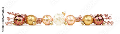 Christmas border of gold and copper decorations isolated on a white background