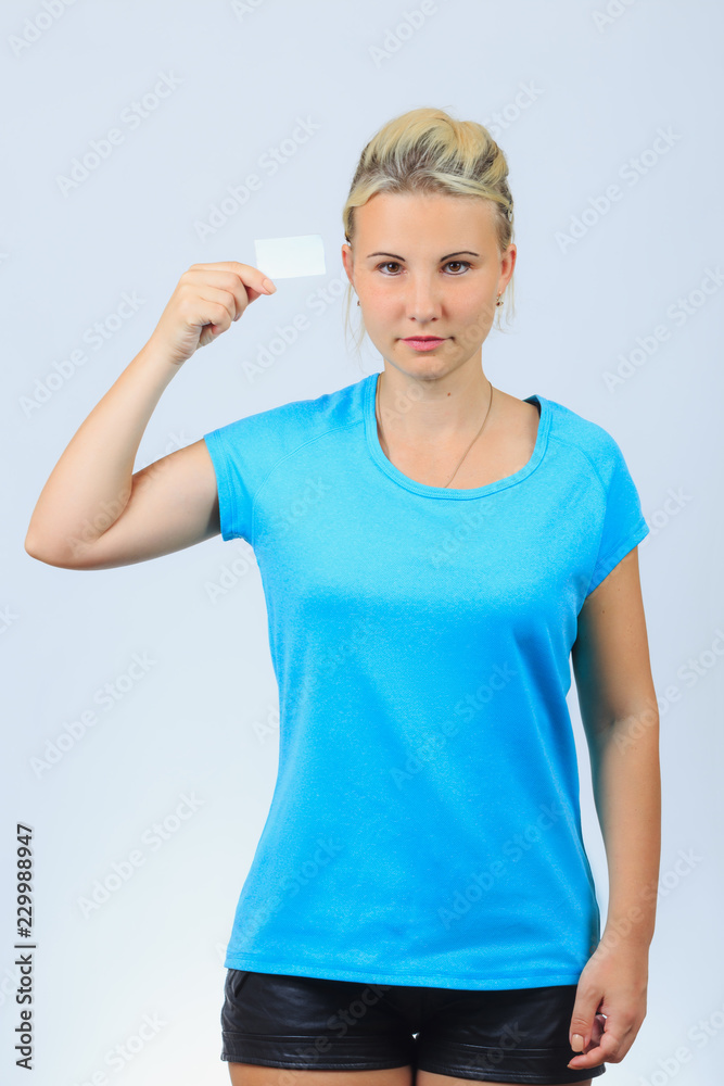 Fototapeta premium Young blonde girl holds business card