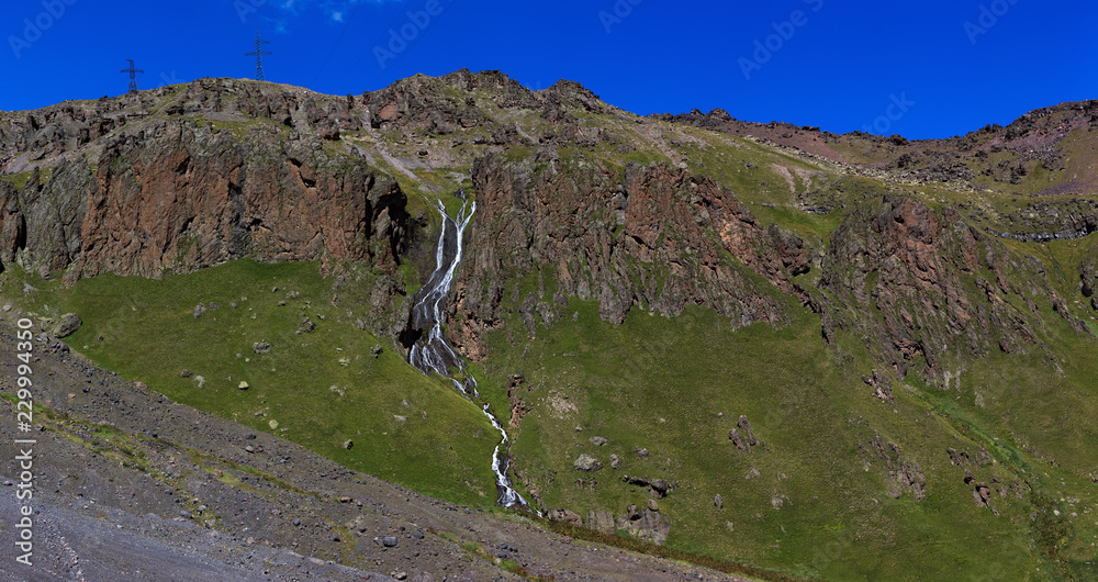 Waterfall on the rocky slopes of the Caucasus Mountains in Russia.