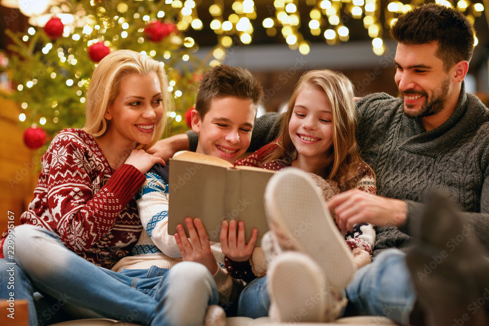 happy family on Christmas holiday reading book. happy family on Christmas holiday reading book.