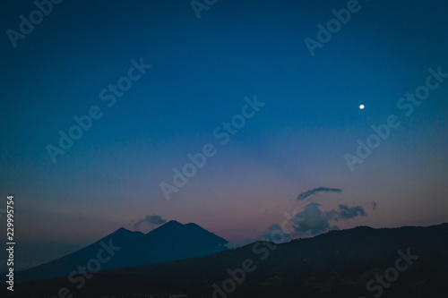 Moon over Fuego and Acatenango volcanoes at sunrise in Guatemala © Allen E Sullivan