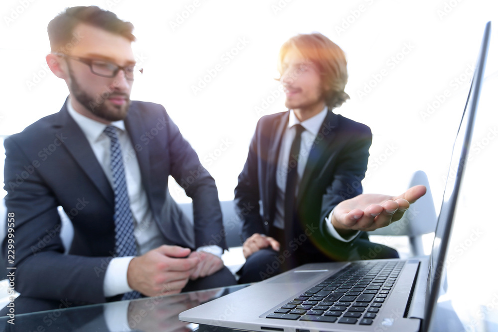 Two businessmen working on a project together Two businessmen working on a project together