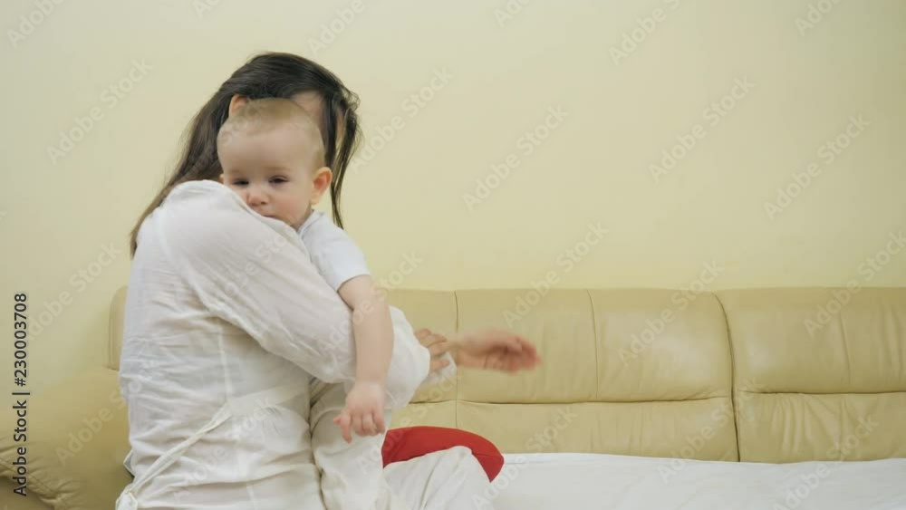 Lovely baby in mothers arms, woman holding child, tenderness expression Lovely baby in mothers arms, woman holding child, tenderness expression