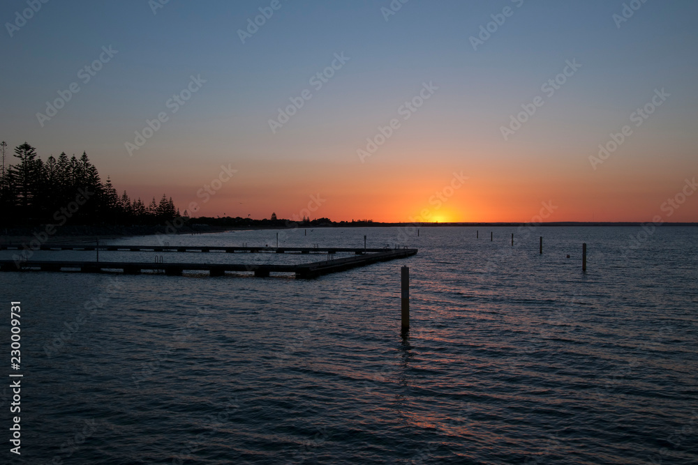 Busselton Australia, Sunset over Geographe Bay with ocean bathes in foreground Busselton Australia, Sunset over Geographe Bay with ocean bathes in foreground
