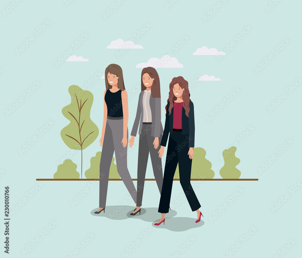 elegant businesswomen walking in the park elegant businesswomen walking in the park