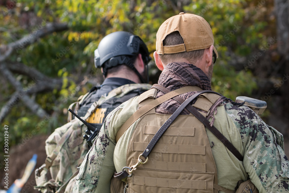 Two officers wearing tactical gear Two officers wearing tactical gear