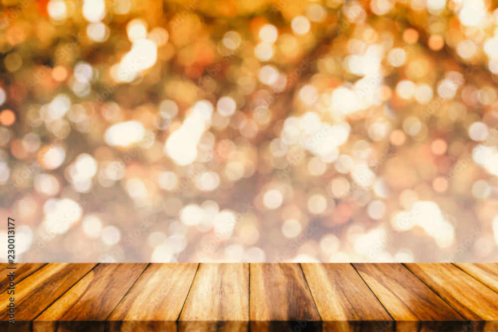 Empty wood table with bokeh abstract yellow background.