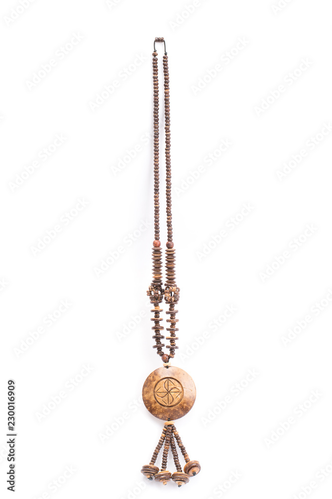 A handmade coconut shell necklace on a white background. A handmade coconut shell necklace on a white background.