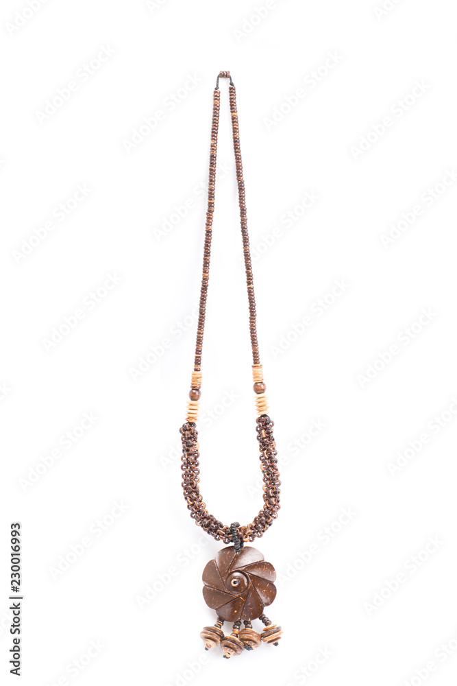 A handmade coconut shell necklace on a white background. A handmade coconut shell necklace on a white background.