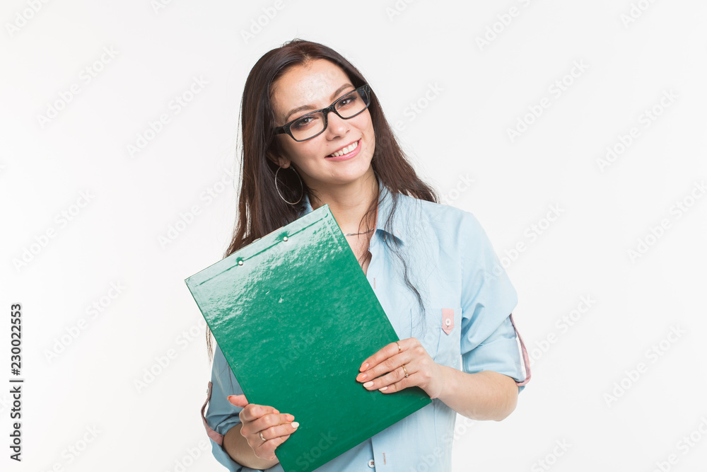 Young woman student with the green folder is standing on white background Young woman student with the green folder is standing on white background