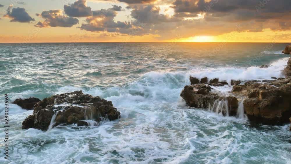 Wave splashing on the sea at sunset. 4K nature composition. Force of storm power. Wave splashing on the sea at sunset. 4K nature composition. Force of storm power.