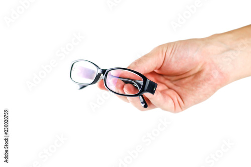 Hand holding glasses for eyes. Close up. Isolated on white background