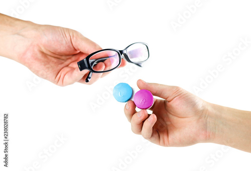 One hand holds the glasses, the second holds the lenses for the eyes. Close up. Isolated on white background