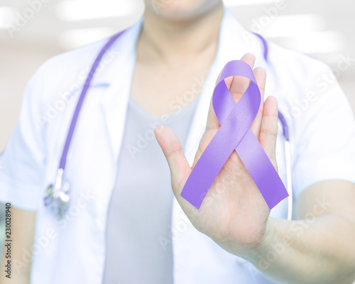 Female doctor in white uniform with purple awareness of ribbon in hand for ADD,ADHD,Alzheimer's Disease ,Arnold Chiari Malformation,Childhood Hemiplegia & stroke, Epilepsy, Chronic & Acute Pain,Crohns photo