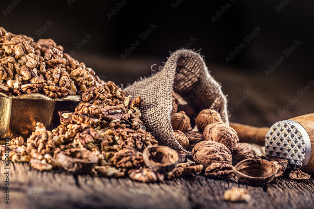 Walnut kernels whole walnuts in burlap sack and vintage bowl Walnut kernels whole walnuts in burlap sack and vintage bowl