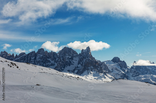 Dolomites  ski area with beautiful slopes. Empty ski slope in winter on a sunny day. Prepare ski slope  Alpe di Lusia  Italy