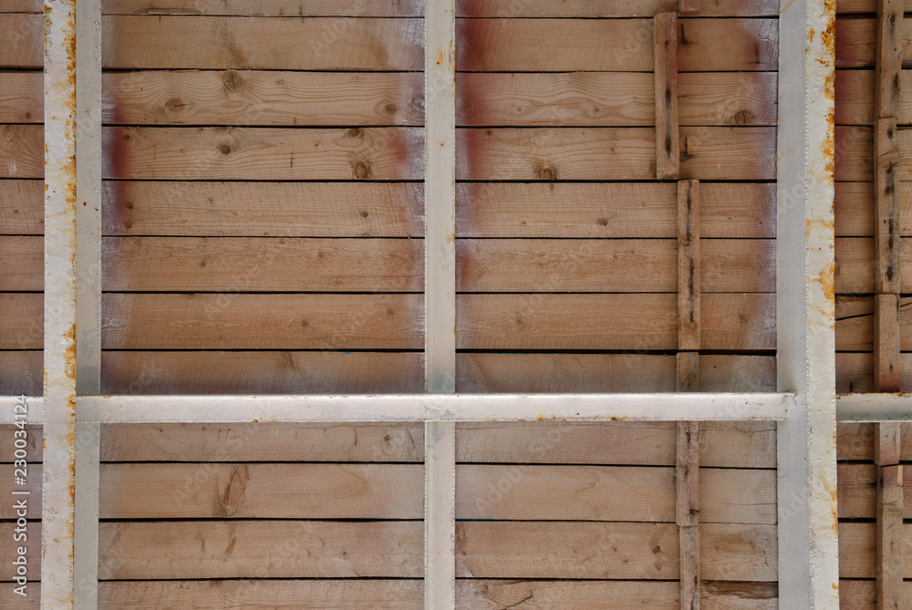 Bottom view of wooden boardwalk on metal joists. Bottom view of wooden boardwalk on metal joists.