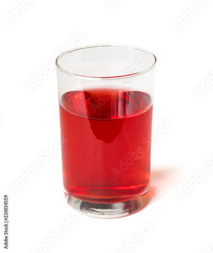 Fresh pomegranate juice in a glass beaker isolated on white background