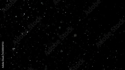 White Snow Falling on Isolated Black Background, Shot of Flying Snowflakes Bokeh, Dust Particles or Powder in the Air. Holiday Overlay Effect photo