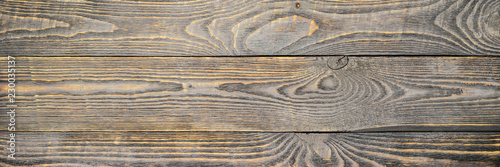 Background of wooden texture boards with yellow color remnants of gray paint. Horizontal.