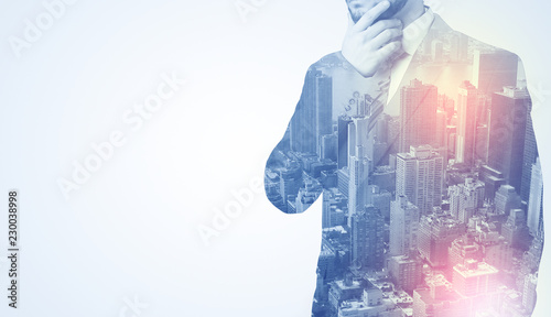 Businessman in suit standing thinking with metropolis graphic  photo